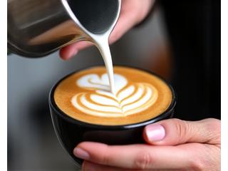 Person learning latte art during barista training